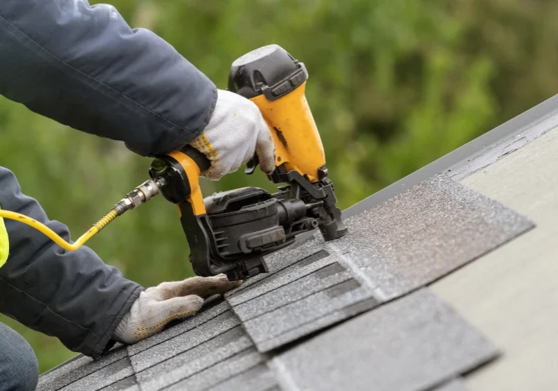 Roofing professional securing asphalt shingles